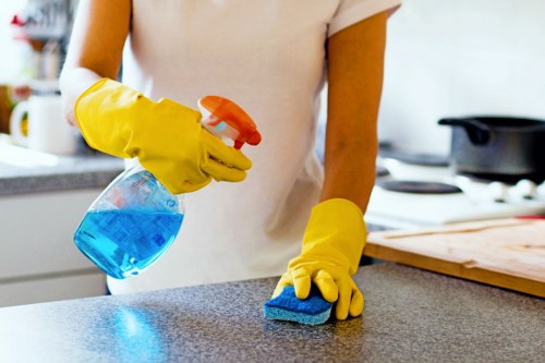 Employee following safe working practices during cleaning